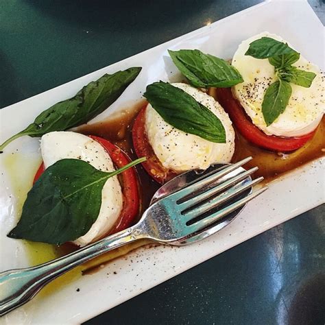 Step 1. While mozzarella is cold, slice it into ¼-inch slices. Let it sit, loosely covered, to come to room temperature while you prepare the tomatoes. Step 2. Slice the tomatoes into ¼-inch to ½-inch thick slices, leaving them in a single layer on the cutting board as you go. Sprinkle generously with salt. 